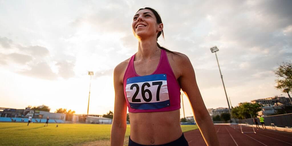 A young woman has just run in a race on a track without glasses or contacts.